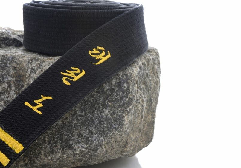 Black belt on a rock (tae kwon do embroidered on the belt).